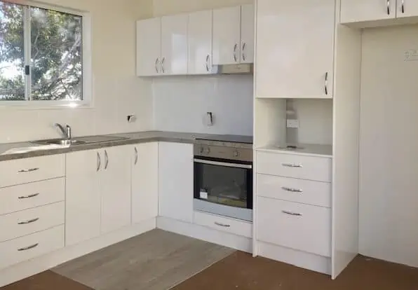 A white kitchen layout in a granny flat