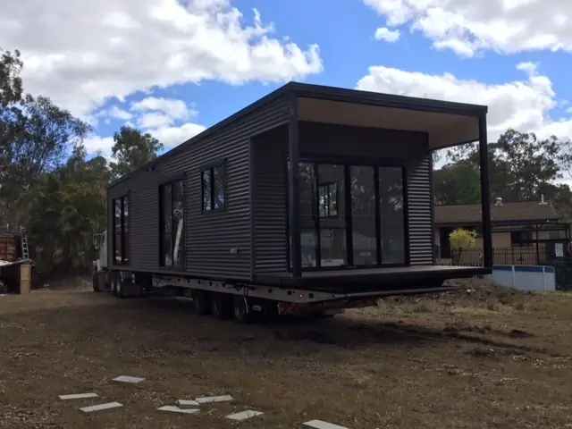 Modern park cabin with dark cladding