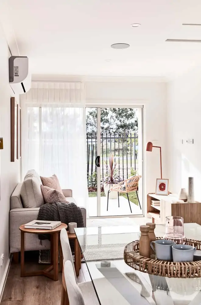 Interior of a modern granny flat home, with sliding glass doors leading outside.