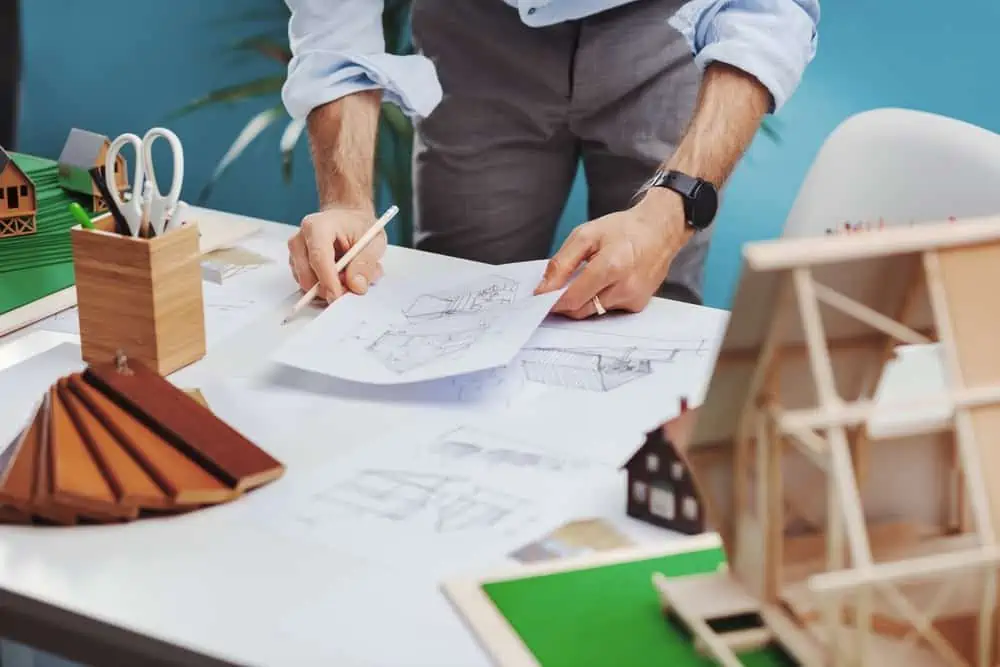 A young architect is checking over plans.